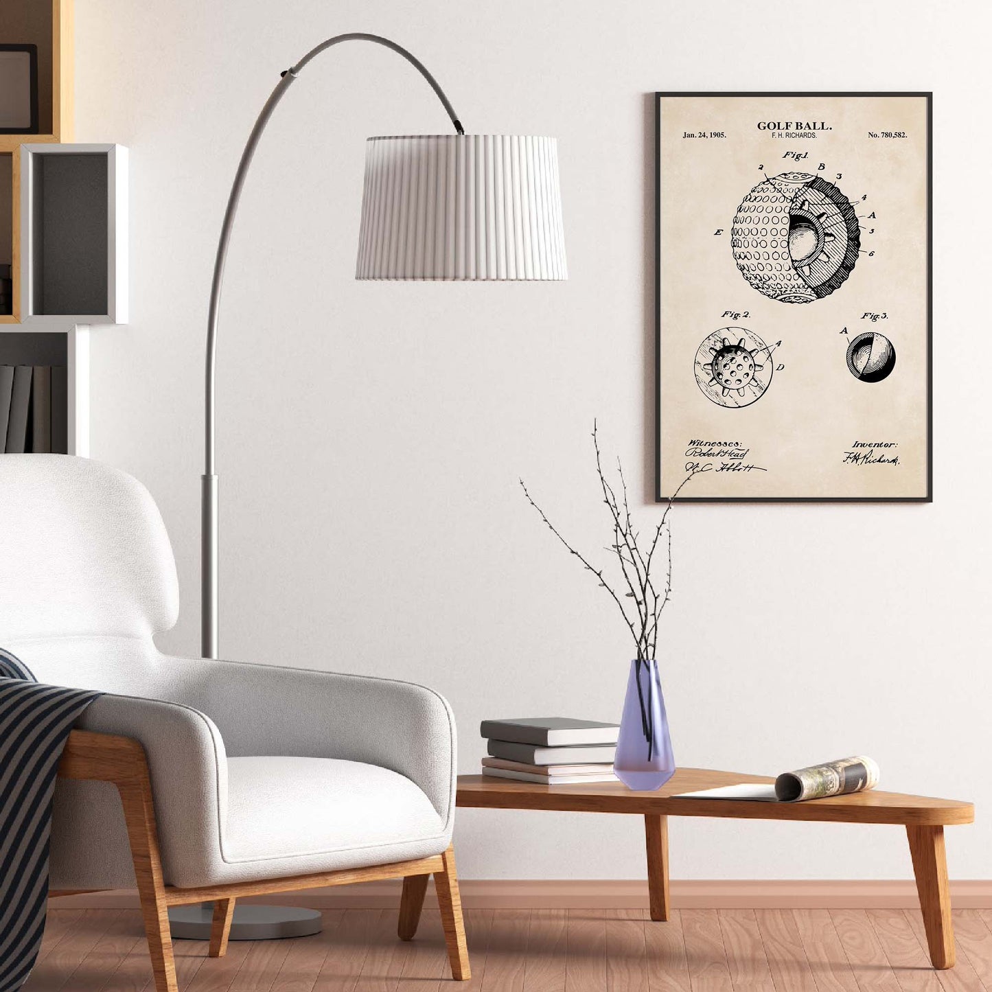 Living room with a white armchair, floor lamp, and framed golf ball patent print on the wall.
