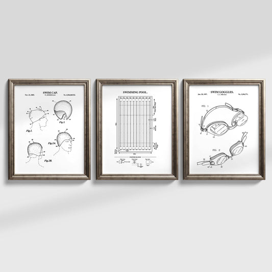 Three framed patent prints of swim goggles on a white wall
