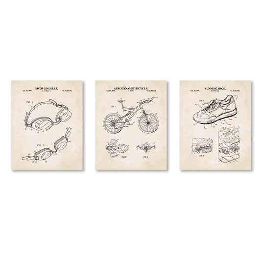 Three framed patent prints of swim goggles, bicycle, and running shoe on a white background.