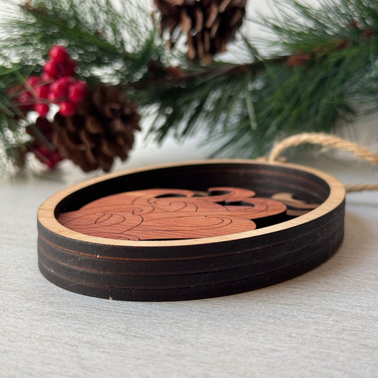 Close-up side view showing dimensional layers of handcrafted octopus wood ornament