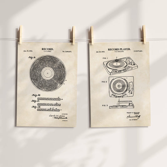 Set of 2 vinyl record patent style prints in a vintage beige color hanging from a white string with clothes pins.