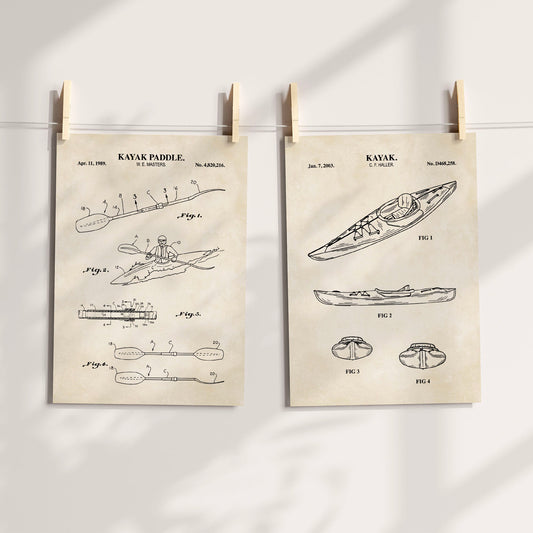 Two vintage-style patent prints for kayaks and paddles hang from wooden clips on a string against a white wall with soft shadow overlays. The prints feature black technical drawings and text on aged cream paper.