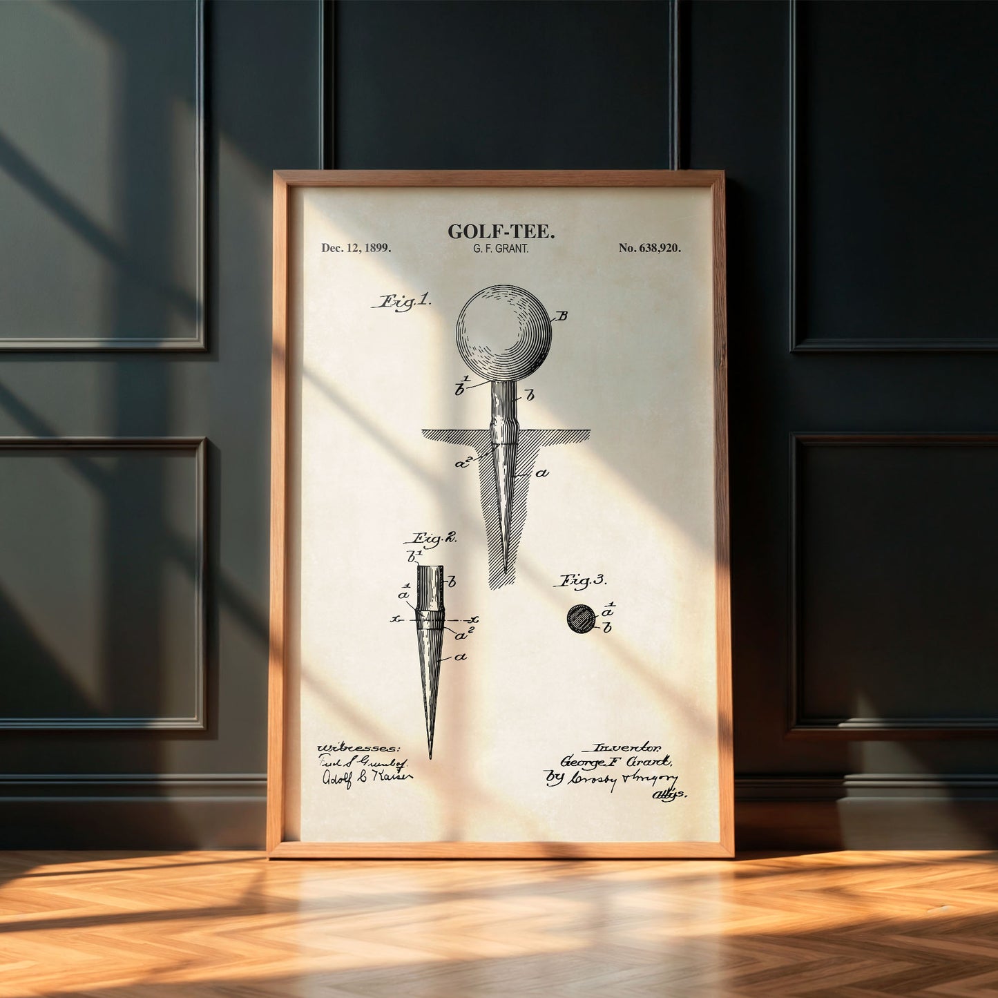 Framed vintage golf tee patent print on a wall.