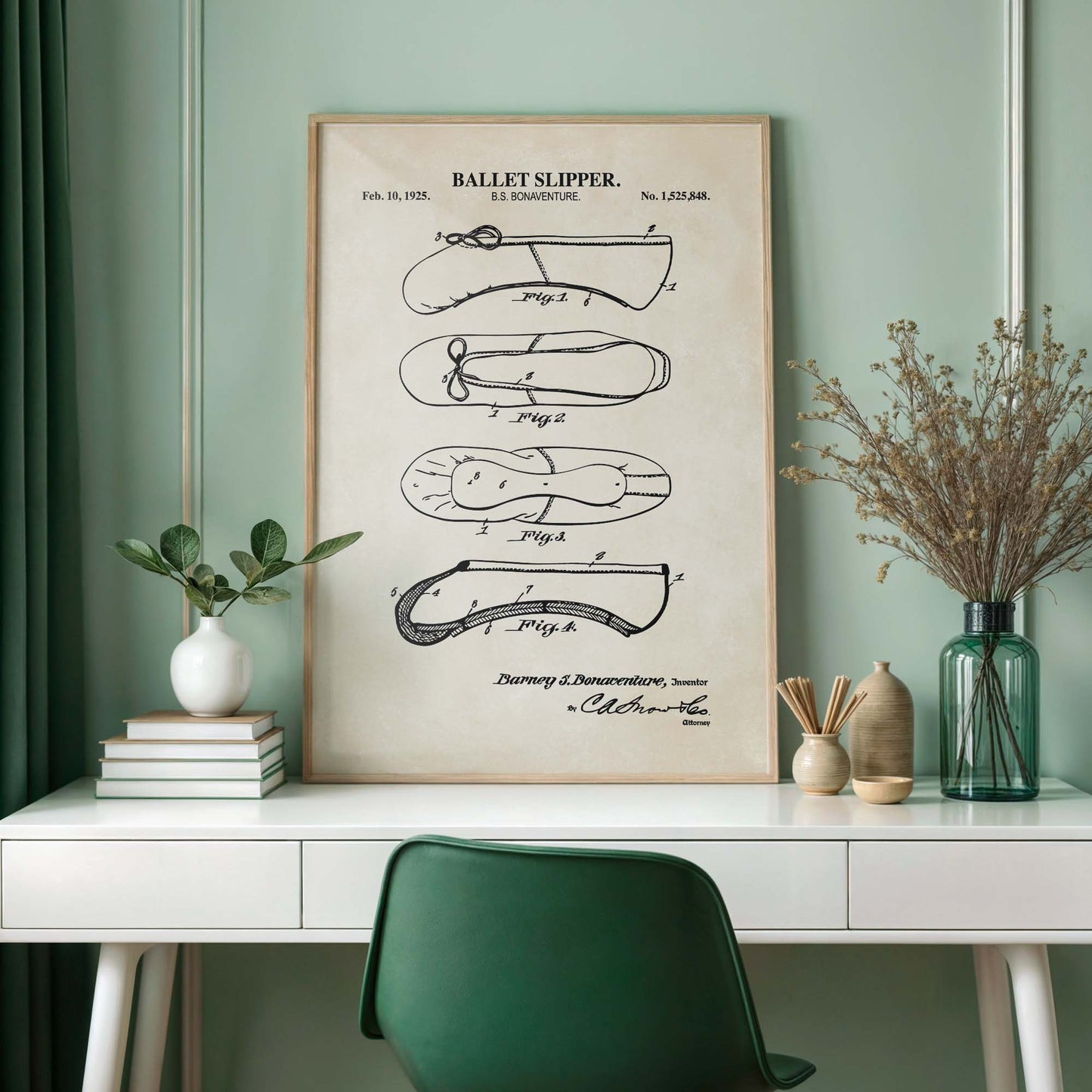 Ballet slipper patent poster on a wall above a desk with decor items.