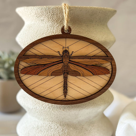 Wooden ornament with dragonfly design on a textured surface