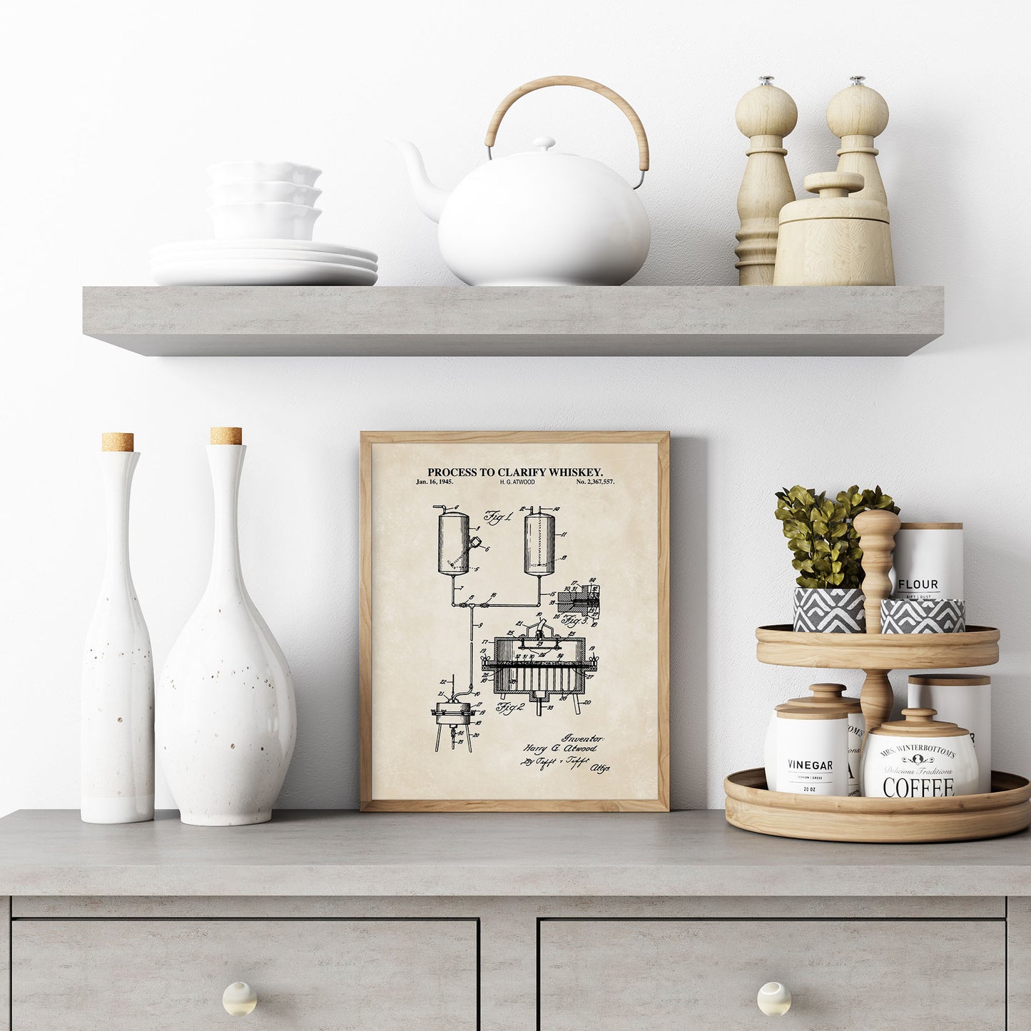 Decorative shelf with a framed whiskey clarifying process diagram, vases, and kitchen items.