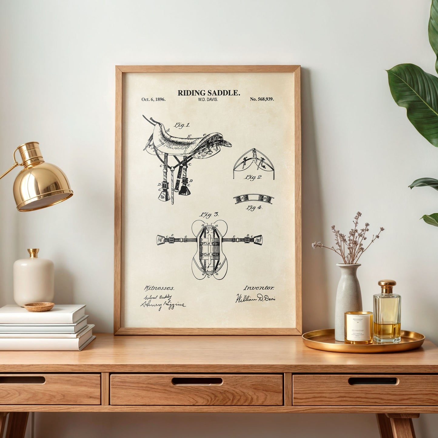Framed poster of a riding saddle design on a wooden desk with decorative items.