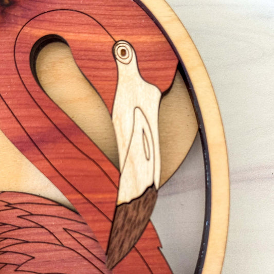 Wooden flamingo ornament on a plain background