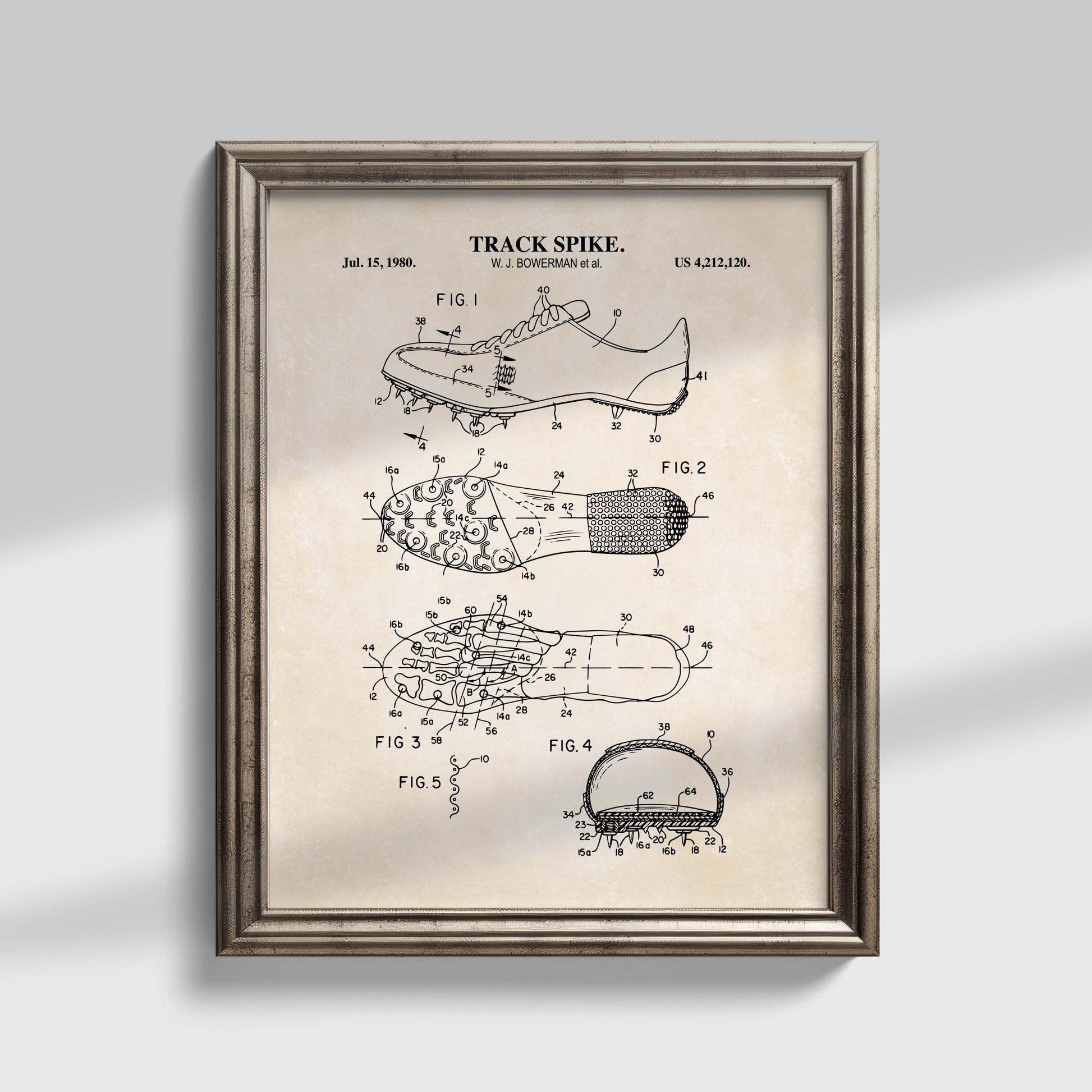 Framed patent poster of a track spike on a gray background