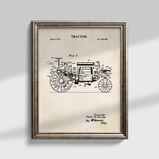 Framed vintage tractor patent art print with a black technical line drawing on an aged beige background, shown in a distressed silver frame against a light gray wall.