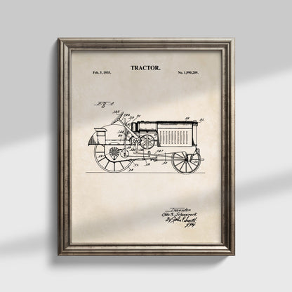 Framed vintage tractor patent art print with a detailed black line drawing on an aged beige background, shown in a distressed silver frame against a light gray wall.