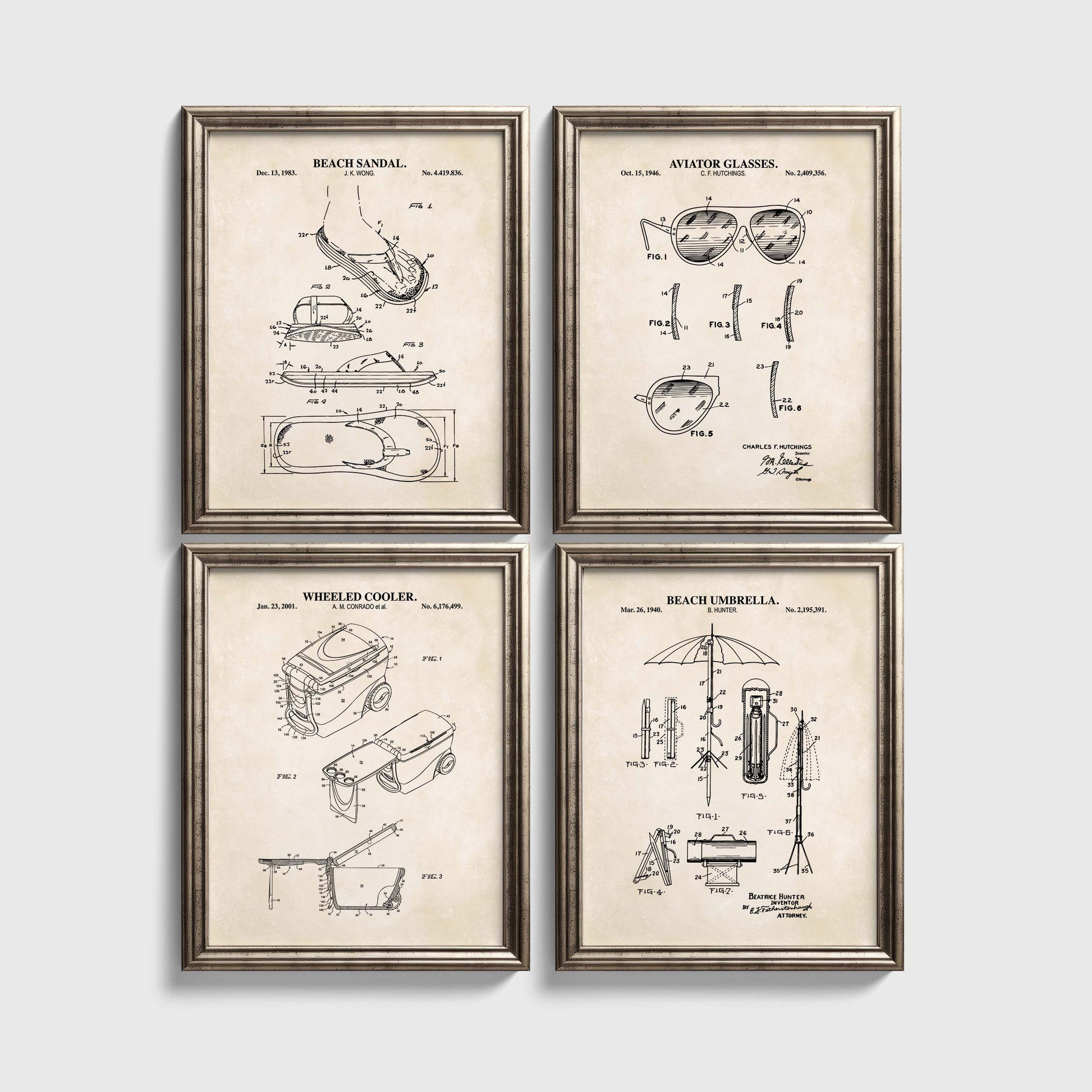 Four framed beach themed patent prints on a white wall