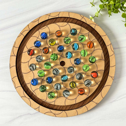 Wooden marble solitaire game with colorful marbles on a white surface