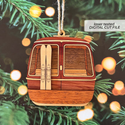 Layered ski gondola ornament SVG laser cut file featuring a front-facing wooden gondola cable car ski lift with skis.