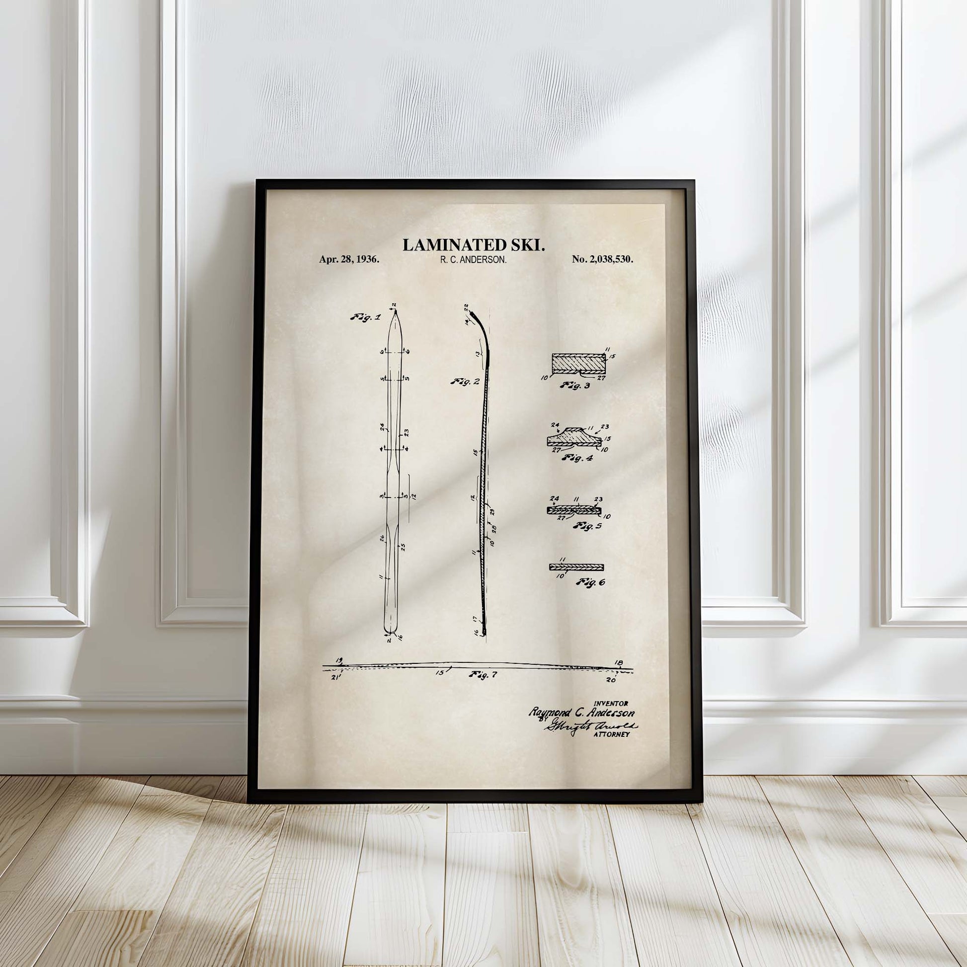 Framed patent poster of a laminated ski on a wall.