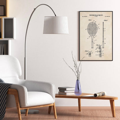 Living room with a white armchair, floor lamp, and wall art of a tennis racket design.