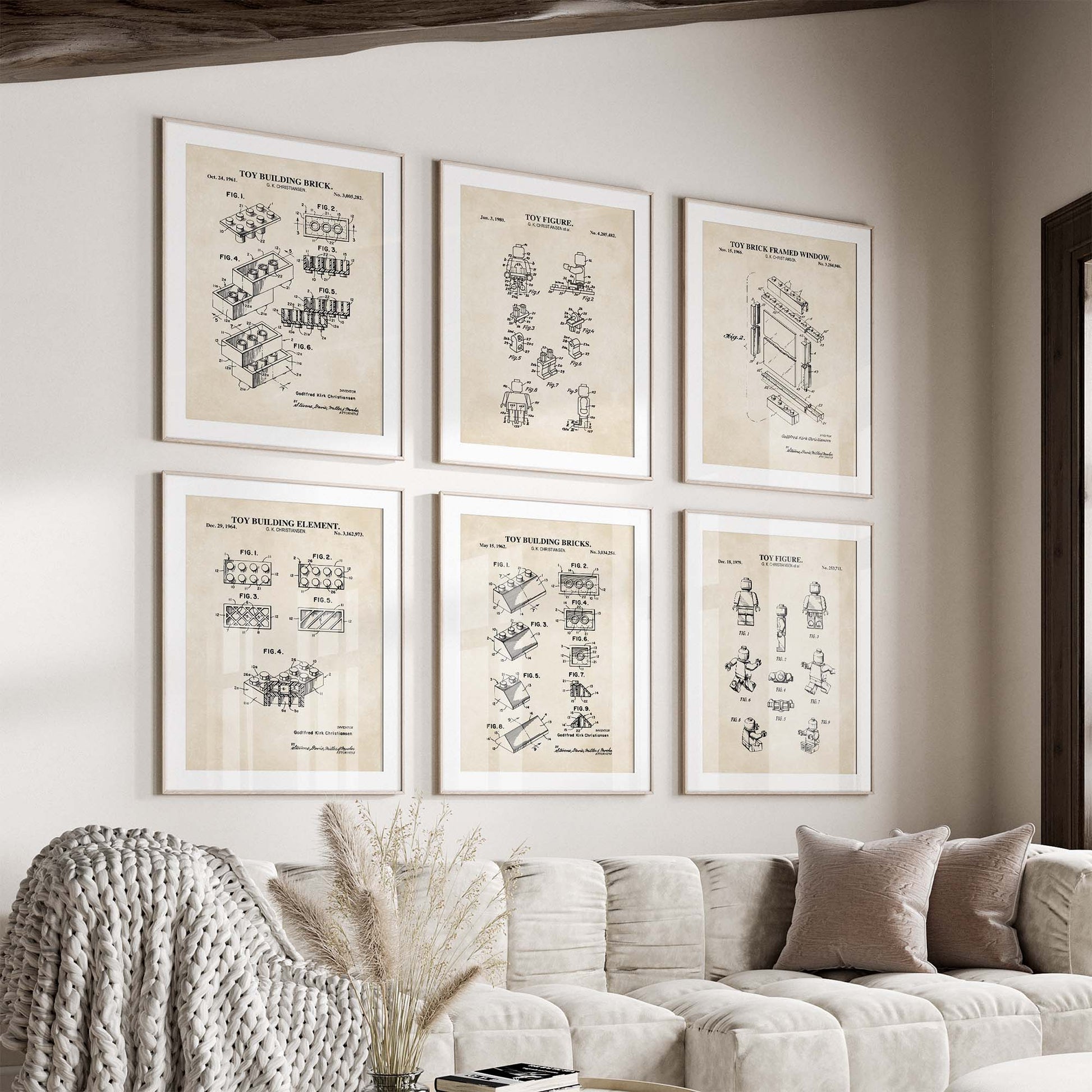 Set of six framed vintage-style technical drawings of toy building bricks on a wall above a sofa.