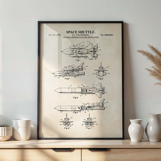Framed space shuttle blueprint poster on a wall above a wooden shelf with decorative vases.