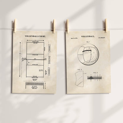 Two vintage-style volleyball-themed art prints clipped to a string with wooden clothespins against a light wall. The left print shows a labeled volleyball court diagram, and the right print shows a vintage patent-style illustration with the word VOLLEYBALL at the top.