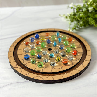 Wooden board game with colorful marbles on a white surface