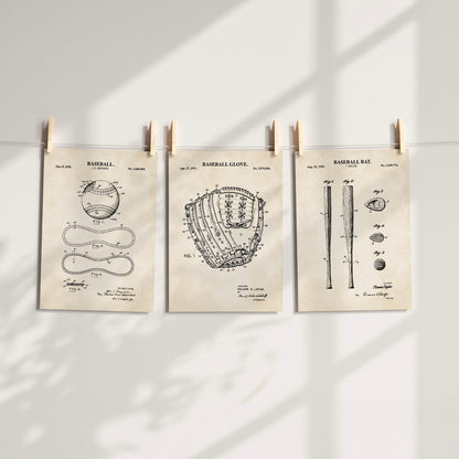 Three vintage-style baseball patent art prints are clipped to a string against a white wall, with soft window shadows cast across the scene.