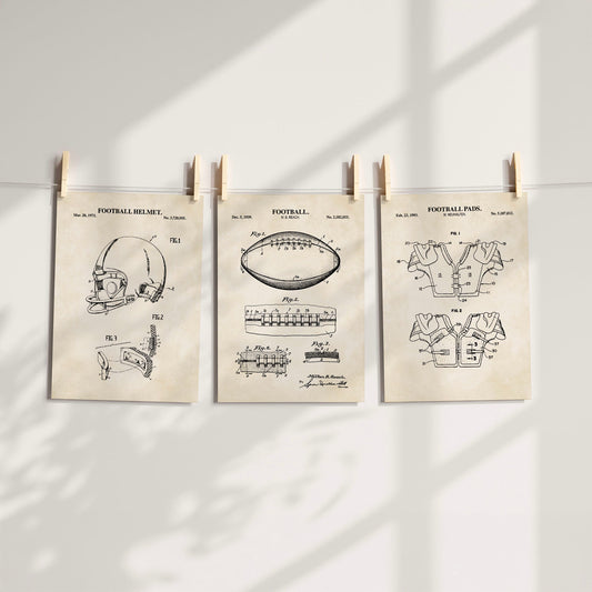 Three vintage-style football-themed patent prints clipped to a string against a white wall with soft shadow overlays.