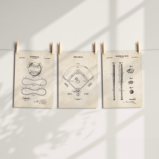 Three vintage-style baseball patent art prints clipped to a string against a white wall with soft window shadow overlays.