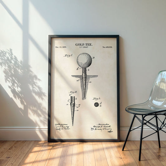Framed golf tee patent print on a wall with a chair and plant in the background
