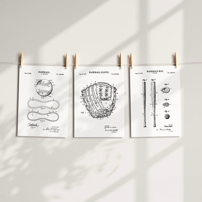 Three white baseball-themed patent art prints clipped to a string against a light wall with soft shadow overlays.