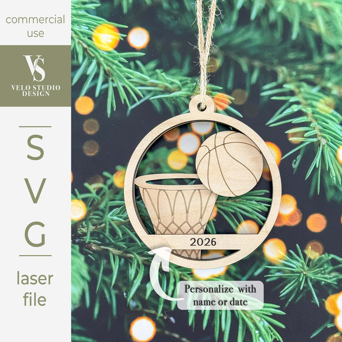 Personalized wooden basketball hoop Christmas ornament shown hanging on a pine tree with warm bokeh lights in the background. The ornament is laser-cut with a basketball graphic and the year