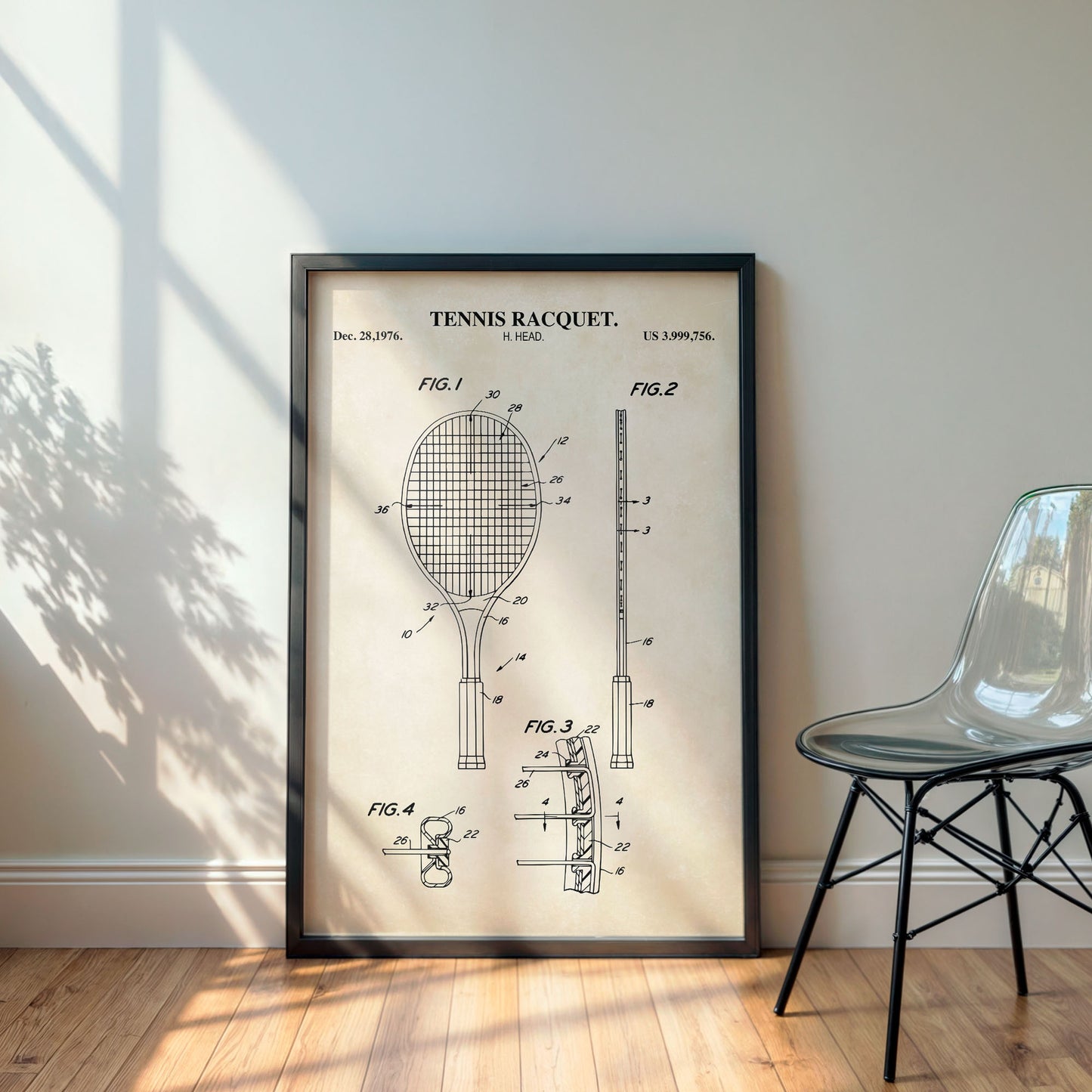 Framed tennis racquet patent poster on a wall with a chair in the corner.