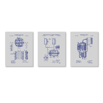 Three framed prints with blueprints of whiskey-making equipment on a white background