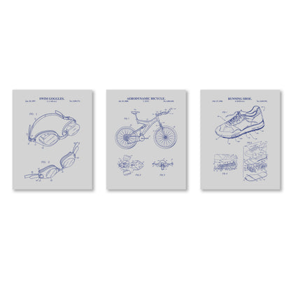 Three framed blueprints of a swim goggles, bicycle, and running shoe on a gray background.