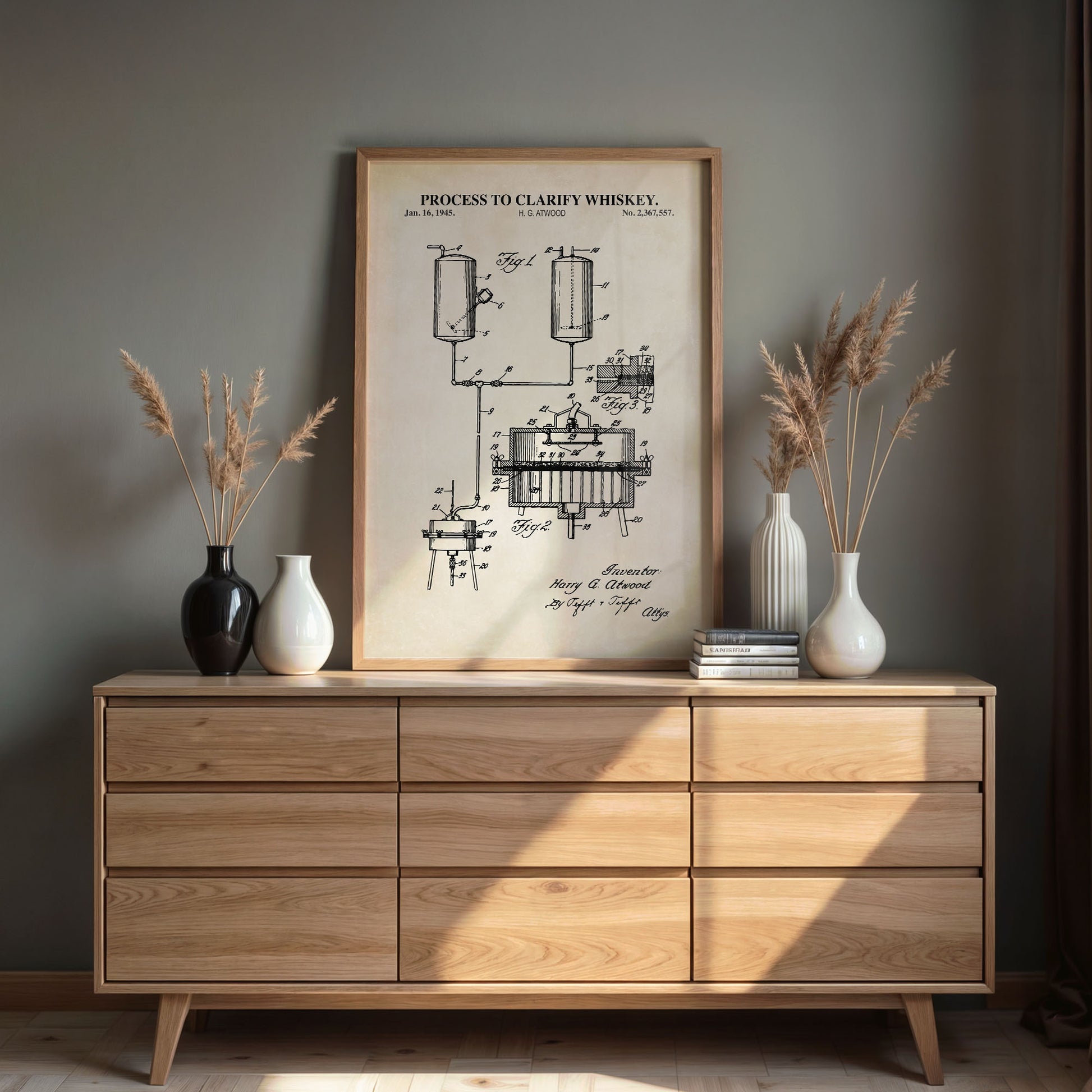 Wooden dresser with framed vintage-style diagram of a process to clarify whiskey on a gray wall