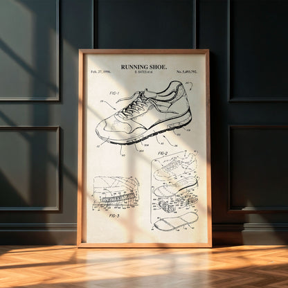 Framed poster of a running shoe patent on a wall with wooden floor