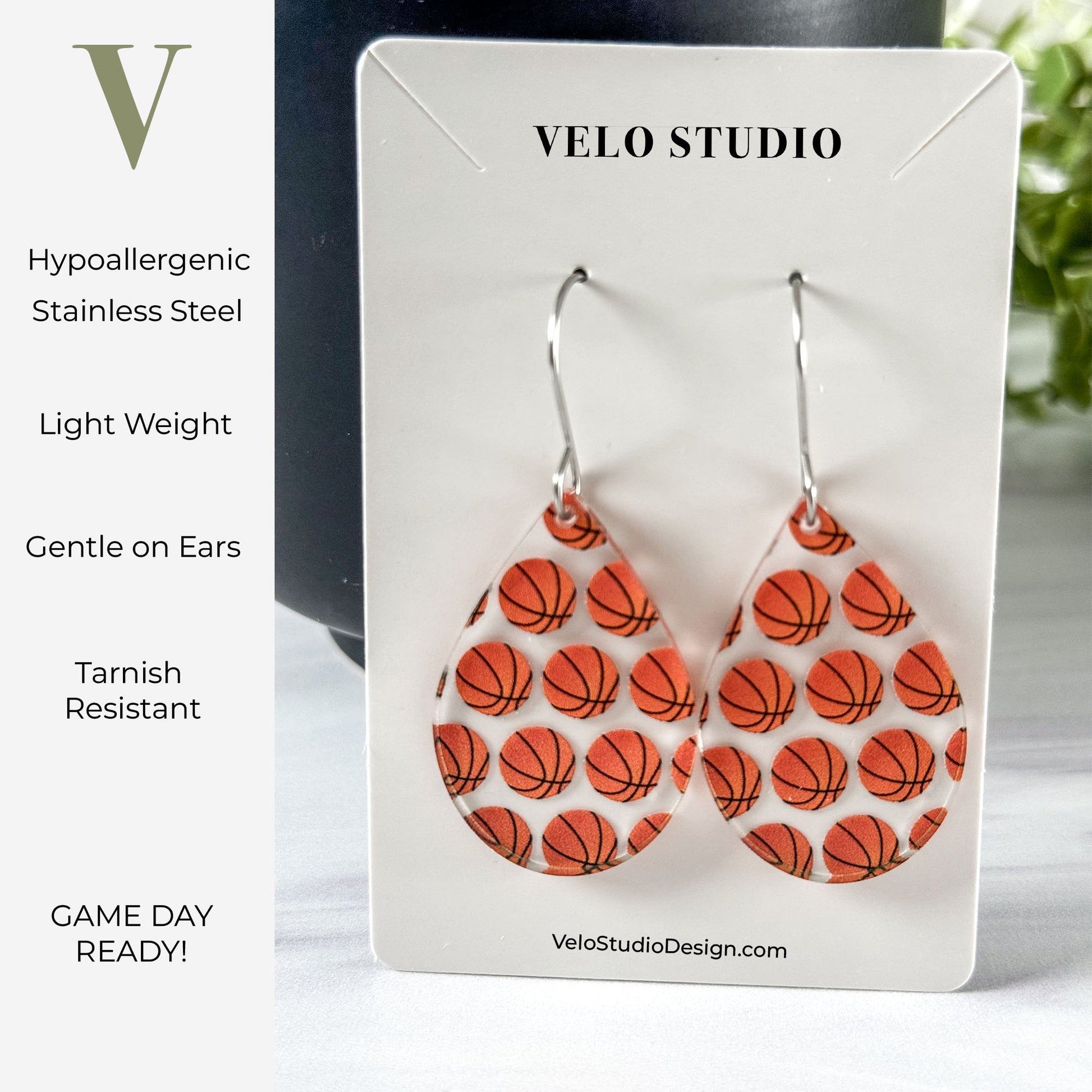 Basketball patterned earrings on a Velo Studio card with product features listed.