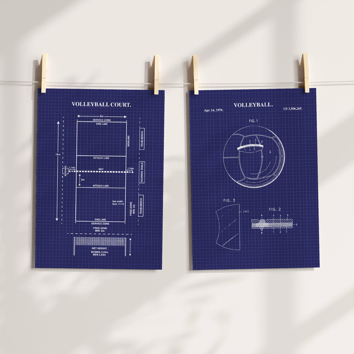 Two navy blue volleyball court patent-style prints clipped to a string against a white wall, with soft shadow overlays.