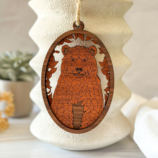 Handcrafted bear wood wall charm displayed against neutral ceramic home decor