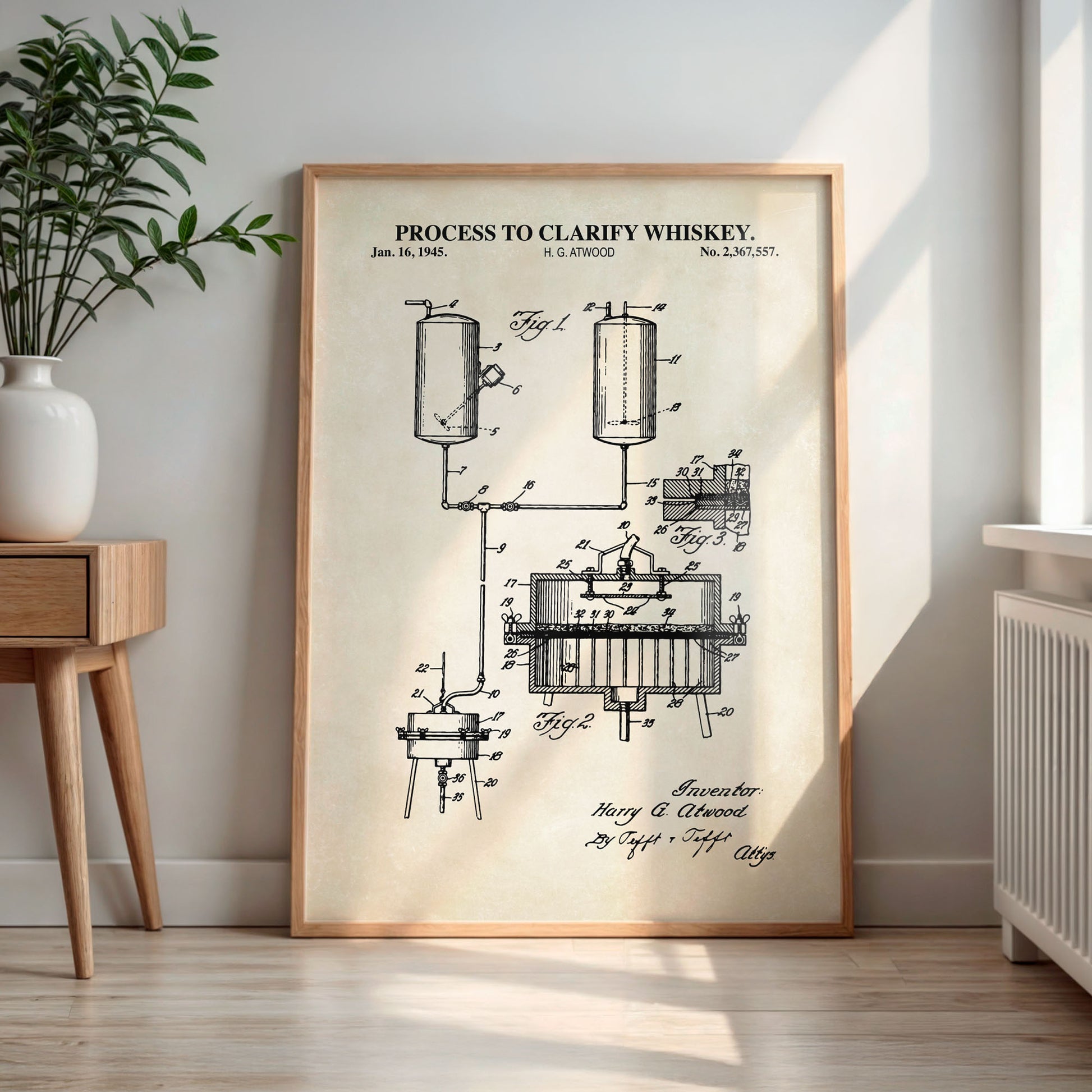 Framed poster of a whiskey clarification process diagram in a room with a plant and wooden side table.