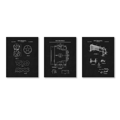 Three black wall art prints showing white patent-style technical drawings labeled soccer ball, soccer field, and soccer goal, displayed side by side on a white background.