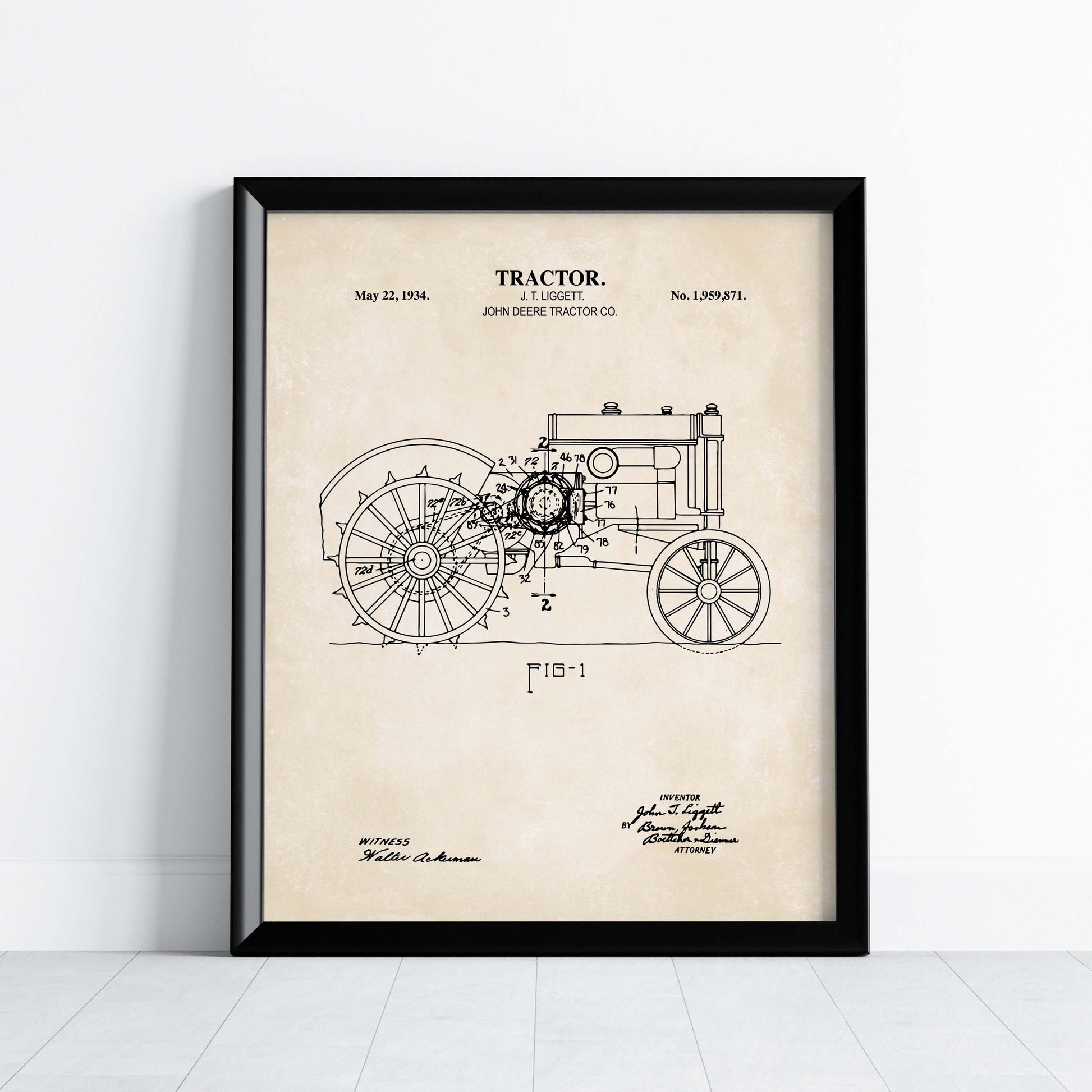 Framed antique tractor patent print on a white wall