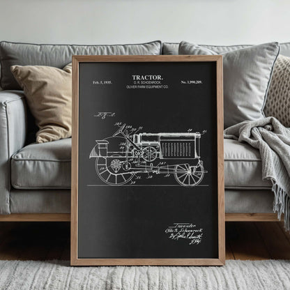 Framed tractor blueprint in front of a couch in a living room setting
