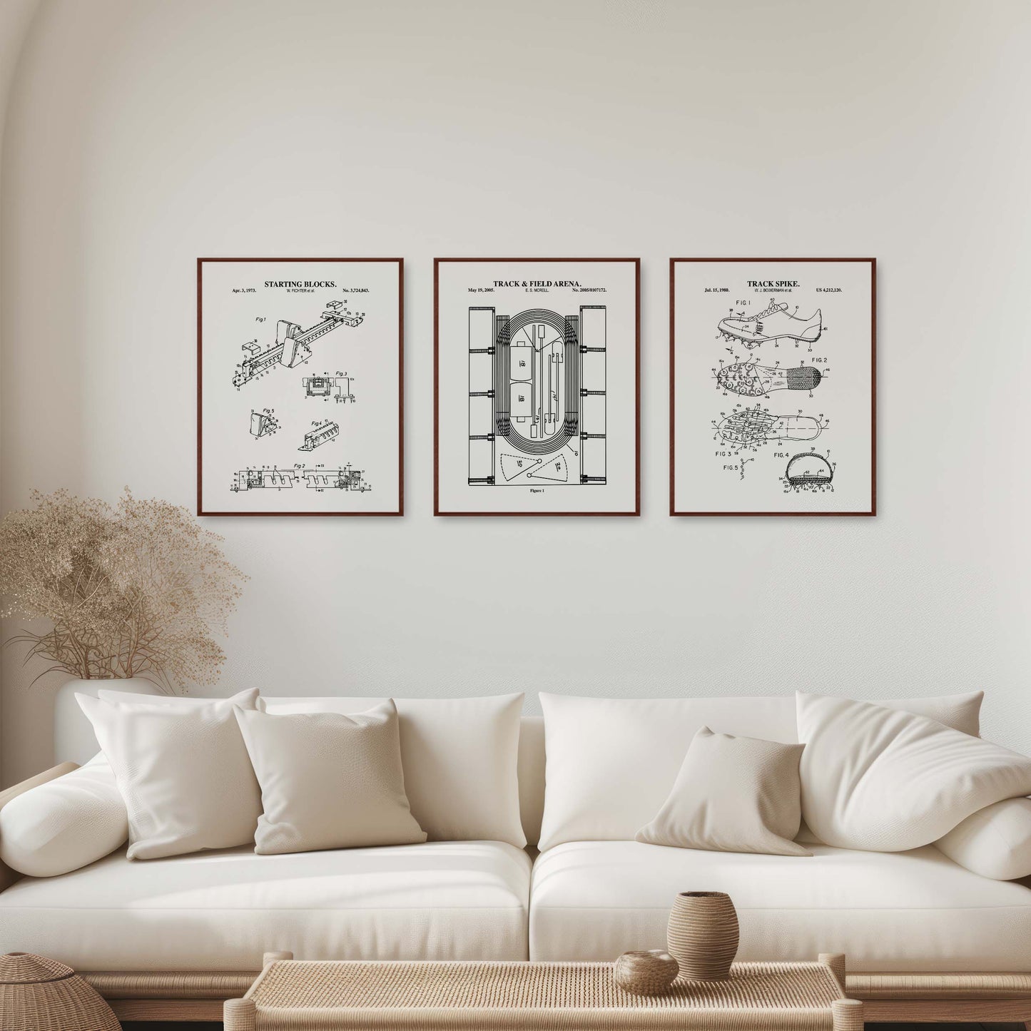 Modern living room with a white sofa, coffee table, and framed track and field drawings on the wall.
