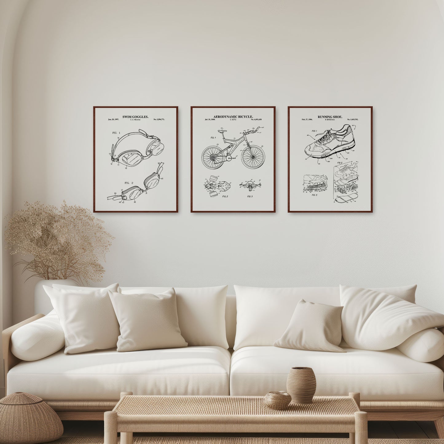 Living room with a white sofa, coffee table, and wall art displaying  triathlon -related patent illustrations.