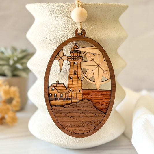 Handcrafted lighthouse wood wall charm displayed against neutral ceramic coastal decor