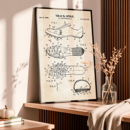 Framed patent poster of a track spike on a wooden shelf with decorative elements.