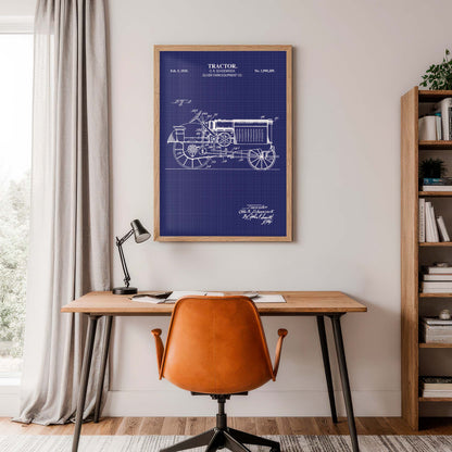 Home office with a desk, chair, and framed tractor blueprint on the wall.