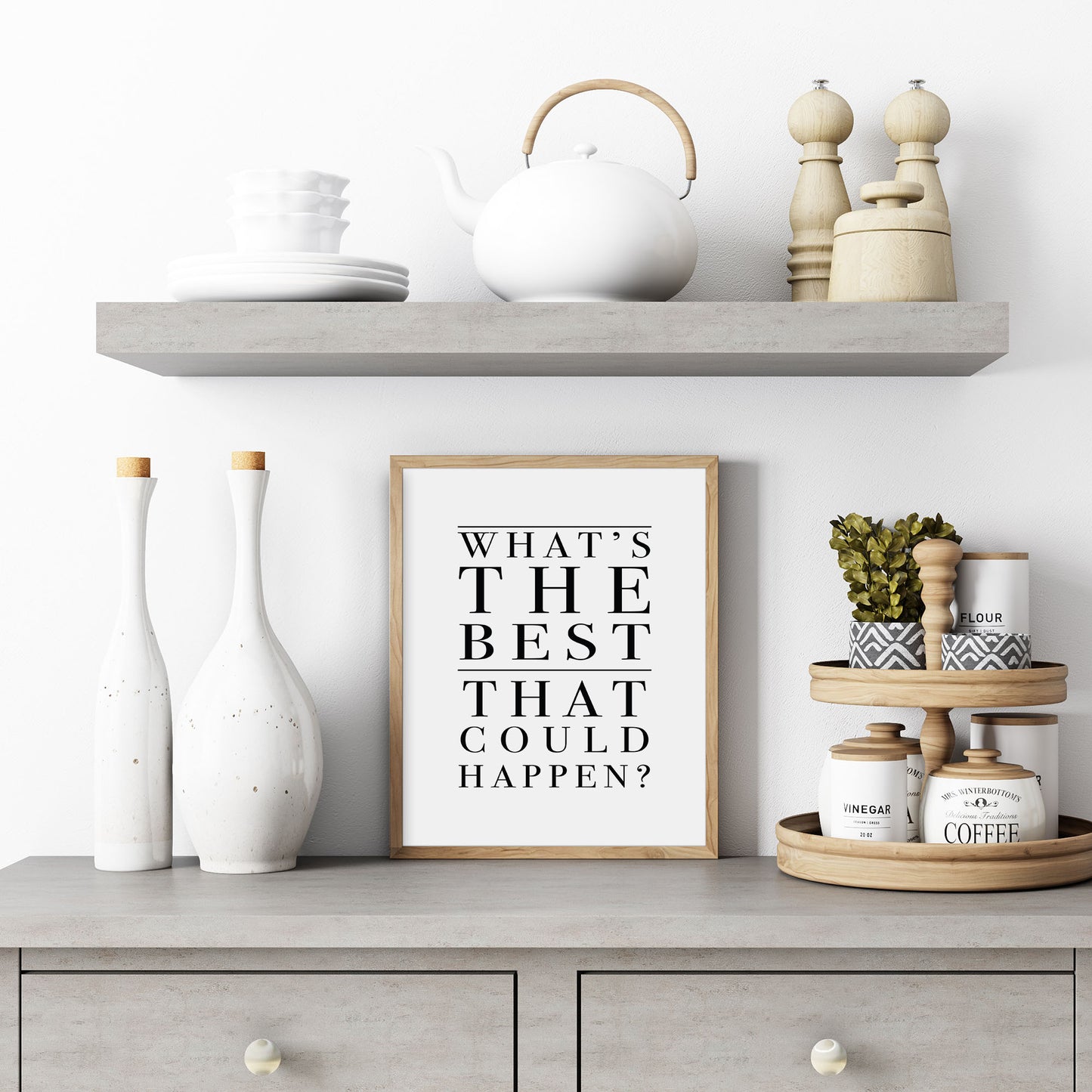 Decorative shelf with a framed quote, vases, and kitchen items against a white wall.