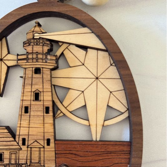Close-up of intricate lighthouse engraving and layered wooden coastal design
