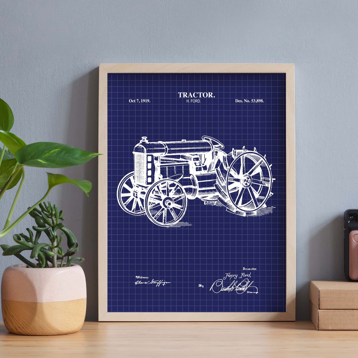 Antique tractor blueprint framed on a desk
